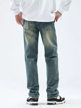 Men’s slim fit jeans in distressed blue denim with a faded wash and straight-leg cut for a modern fit look