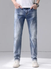 Men’s slim fit jeans in light-wash denim with a straight-leg cut, subtle fading, classic stitching, and belt loops