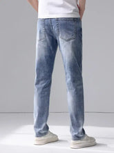 Men slim fit jeans in light-wash denim featuring a straight-leg cut and classic back pockets shown from the back side