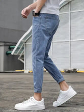 Men’s slim-fit wash jeans in light-wash denim with a slim fit and rolled cuffs for a modern look