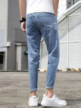 Men’s slim-fit wash jeans in light-wash denim with a slim fit and rolled cuffs for a modern look