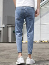 Men’s slim-fit wash jeans in light-wash denim with slim fit cut and rolled cuffs for a modern look