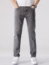 Dark gray slim fit washed denim jeans with a classic five pocket design and subtle thigh fading for men
