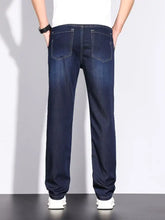 Men’s straight leg jeans in dark blue denim shown from the back with classic rear pockets and white stitching
