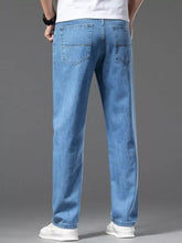 Men’s straight-leg jeans in light-wash blue denim with a straight-leg cut and classic back pockets shown from the back