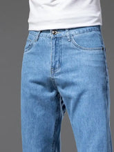 Men’s straight-leg jeans in light-wash blue denim with classic five-pocket design and button closure