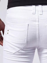 Men’s white denim straight leg jeans shown from the back with slim fit and gold-tone button details on pocket