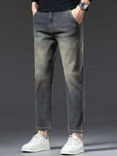 Men’s straight leg vintage wash jeans in dark gray denim with a slightly faded look and rolled cuffs