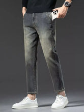 Men’s straight leg vintage wash jeans in dark gray slim fit denim with a faded wash finish