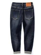 Men’s dark indigo straight leg washed denim jeans with rolled cuffs and brown leather brand tag at waistband