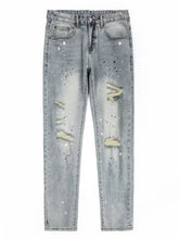 Men’s vintage distressed light wash skinny jeans with ripped knees and white paint splatter accents