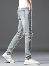 Men’s vintage distressed light wash skinny jeans with ripped details on thighs and knees in light wash denim