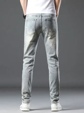 Men’s vintage distressed light wash skinny jeans with slim fit and subtle distressing details in light wash denim