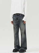 Men’s vintage distressed wide leg jeans in dark-wash denim with a faded distressed look and subtle speckled texture
