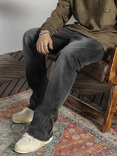 Men’s vintage dark gray denim raw hem jeans with zipper detail on the side for a modern raw hem look