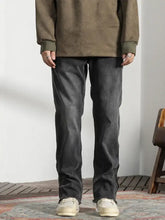 Men’s vintage dark gray denim raw hem jeans with a straight-leg cut and slightly faded frayed hems