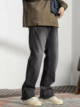 Men’s dark gray denim vintage raw hem jeans with straight-leg cut and zipper detailing at the cuffs