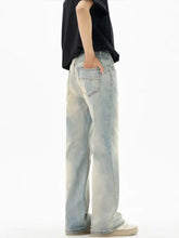 Men’s vintage wash flare jeans in light-wash denim with a relaxed wide-leg cut and subtle fading for a modern look