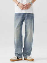 Light-wash denim jeans with a relaxed, straight-leg cut and subtle fading for a casual, modern look.