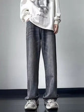 Men’s dark gray denim jeans with a vintage wash loose fit and subtle whiskering detail for casual wear