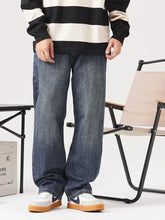 Men’s vintage wash loose fit blue denim jeans with relaxed straight-leg cut and subtle fading