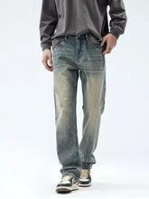 Distressed blue denim men’s vintage wash loose fit jeans with faded vintage wash and straight-leg cut