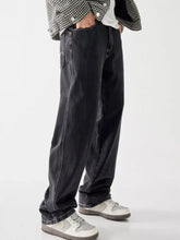 Men’s vintage wash loose fit black denim jeans with wide-leg cut and subtle white stitching details