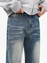 Men’s vintage wash loose fit blue denim jeans with faded distressed wash and classic five-pocket design