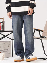 Men’s blue denim jeans with a vintage wash loose fit straight-leg cut and relaxed style in faded wash