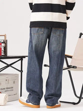 Men’s vintage wash loose fit blue denim jeans with relaxed straight-leg cut and classic stitching details