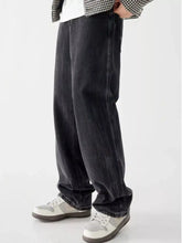 Men’s vintage wash loose fit dark-wash denim jeans with relaxed wide-leg cut and visible stitching along seams