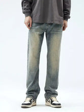 Men’s vintage wash loose fit blue denim jeans with distressed fading and straight-leg cut