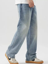 Men’s vintage wash loose fit light-wash denim jeans with a relaxed straight-leg cut and subtle fading for casual wear