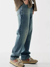 Men’s vintage wash loose fit jeans in washed blue denim with relaxed straight-leg cut and subtle fading