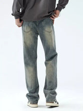 Men’s vintage wash loose fit jeans in washed denim with faded, distressed look and classic five-pocket design
