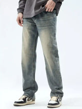 Men’s washed denim jeans with vintage wash loose fit and faded distressed look in straight-leg cut