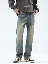 Men’s vintage wash loose fit jeans in washed denim with a faded distressed look and straight-leg cut