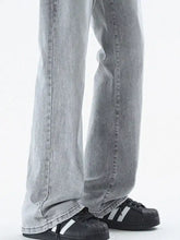 Black adidas superstar sneakers with white stripes and rubber toe caps paired with men’s vintage wash loose fit jeans