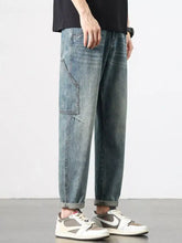 Men’s vintage wash relaxed fit jeans in light-wash denim with tapered fit and cargo-style pockets