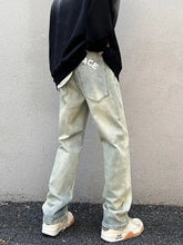 Men’s vintage wash straight leg light-wash denim jeans with faded distressed look and white lettering on back pocket rear view