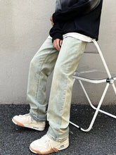 Men’s vintage wash straight leg jeans in light-wash denim with a faded distressed look and subtle leg fading