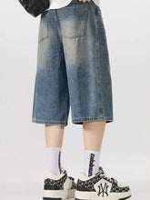 Men’s vintage wash wide-leg capris jeans in blue denim with a faded, distressed look and a wide-leg cut