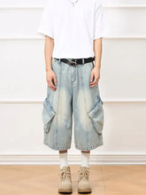Men’s vintage wash wide-leg capris jeans in light-wash denim with large cargo pockets and black belt detail