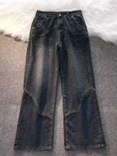 Men’s vintage wash wide leg jeans in dark denim with a flared silhouette and patchwork detailing on outer thighs