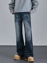 Men’s vintage wash wide leg jeans in dark wash denim with a flared silhouette and subtle distressed detailing