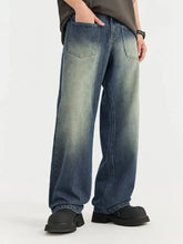 Men’s vintage wash wide leg jeans in faded blue denim with subtle distressing and a vintage wash wide design
