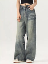 Men’s vintage wash wide leg jeans in faded blue denim with subtle distressing and button fly closure