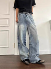 Men’s vintage wash wide leg light-wash denim jeans with a relaxed fit and subtle fading