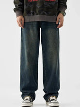 Men’s dark-wash denim jeans with a vintage wash wide leg and relaxed straight-leg cut with visible stitching