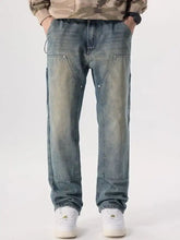 Men’s vintage wash wide leg jeans in washed blue denim with relaxed fit and reinforced patch pockets